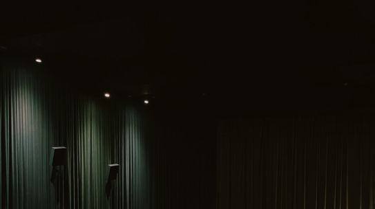 a row of chairs sitting in front of a theater screen